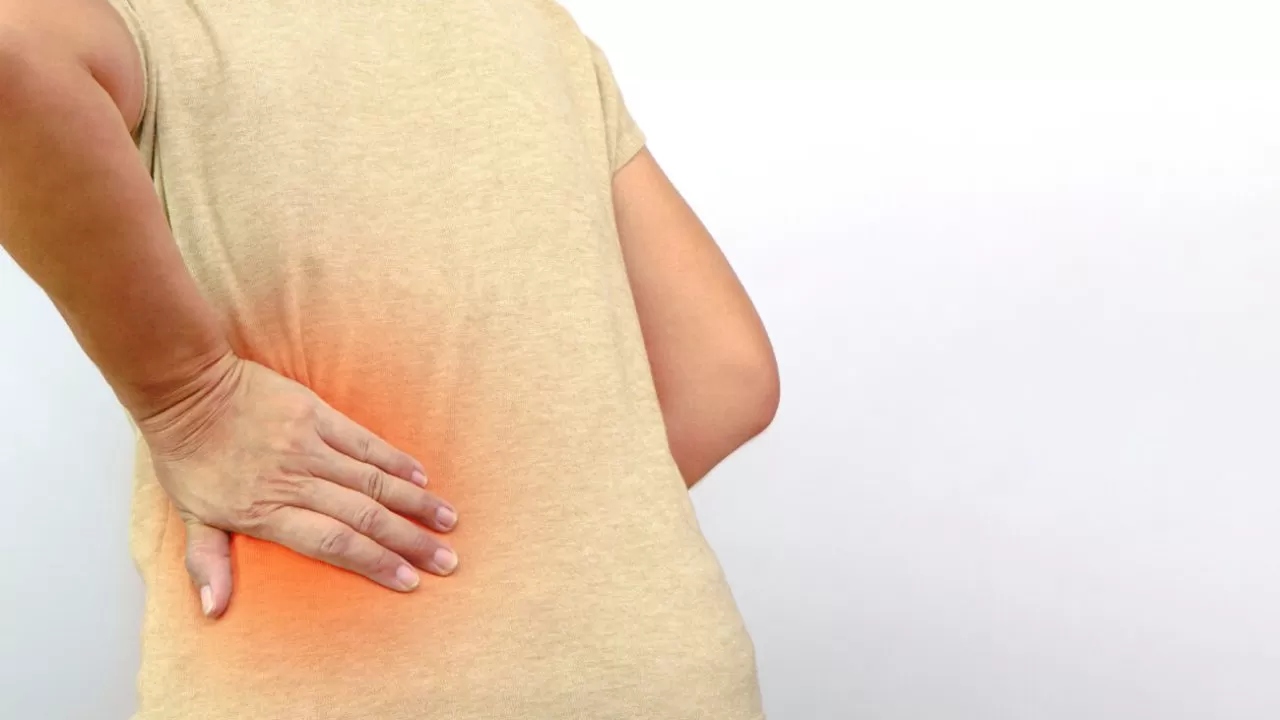Woman hands touching her buttocks area suffering from pain. Health care and medical concept.